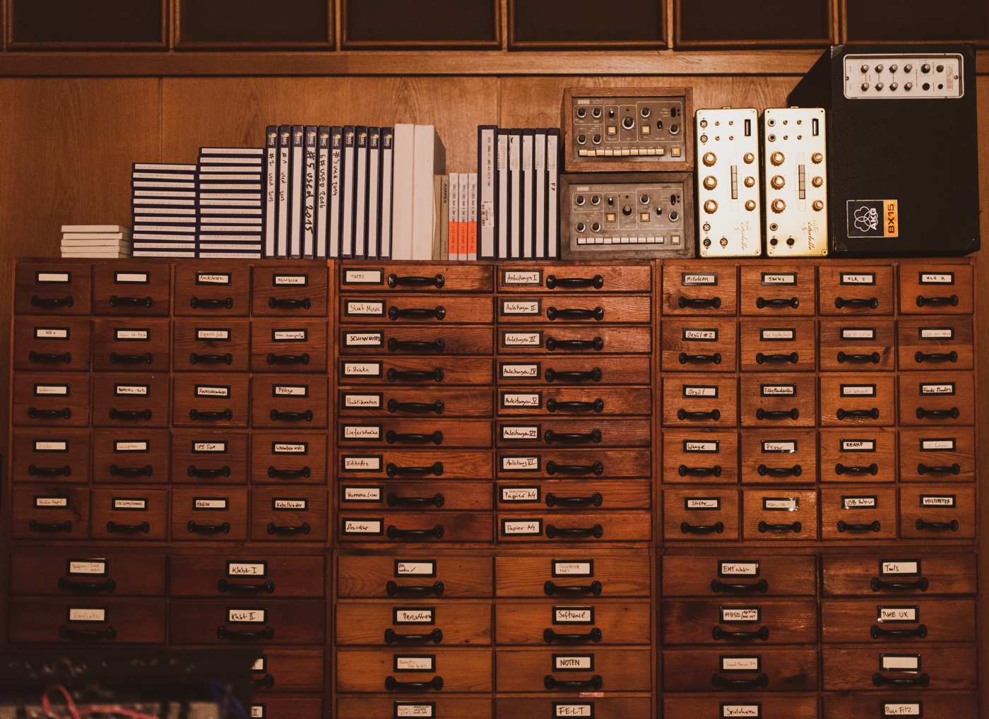 A wall of small wooden cabinets inside Nils Frahm's studio at Funkhaus Berlin.